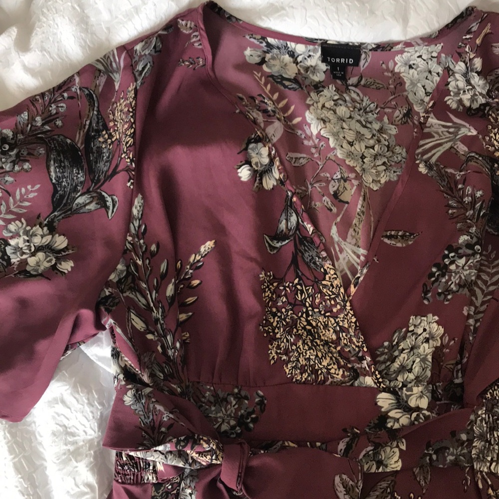 Purple v-neck blouse with floral pattern.